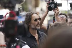 Russell Brand arrives at a London court to face rape and sexual assault charges